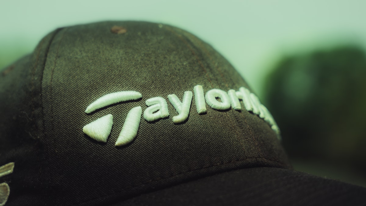 Close-up of a TaylorMade branded golf hat — the crown position is the most valuable real estate in golf sponsorship