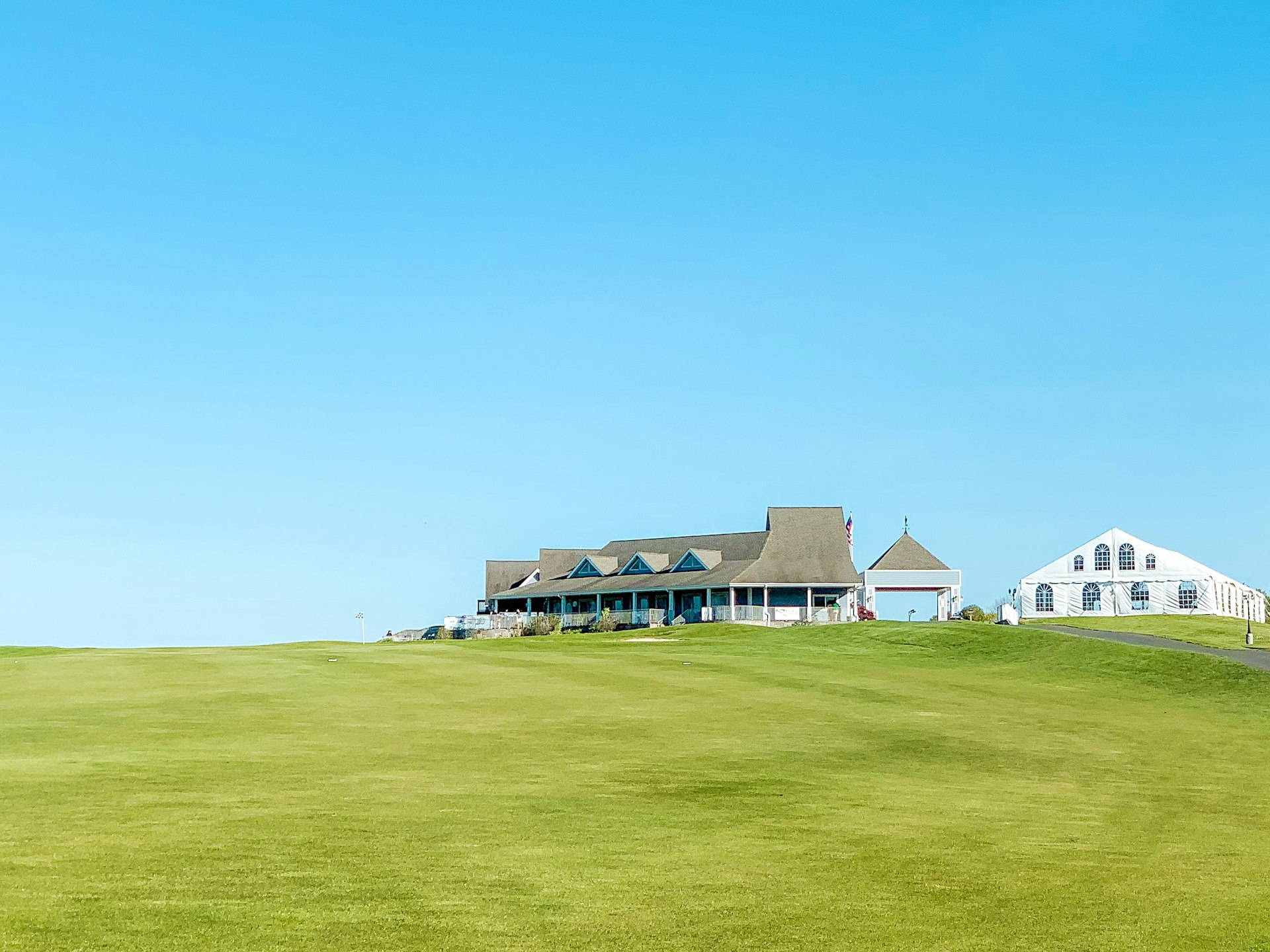 Golf clubhouse on a pristine green fairway